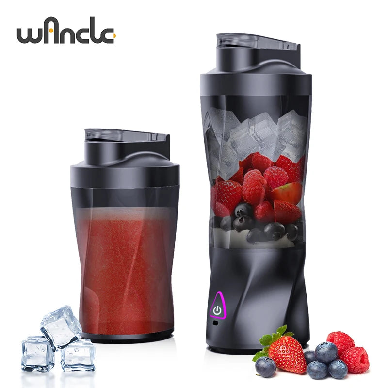 A black portable blender jar filled with red juice, surrounded by fresh berries and ice cubes.