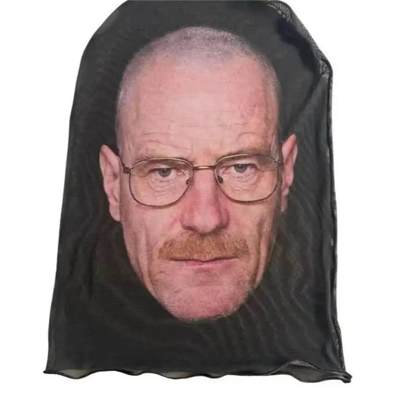 A dark fabric mask depicting a man's face with glasses and a mustache.