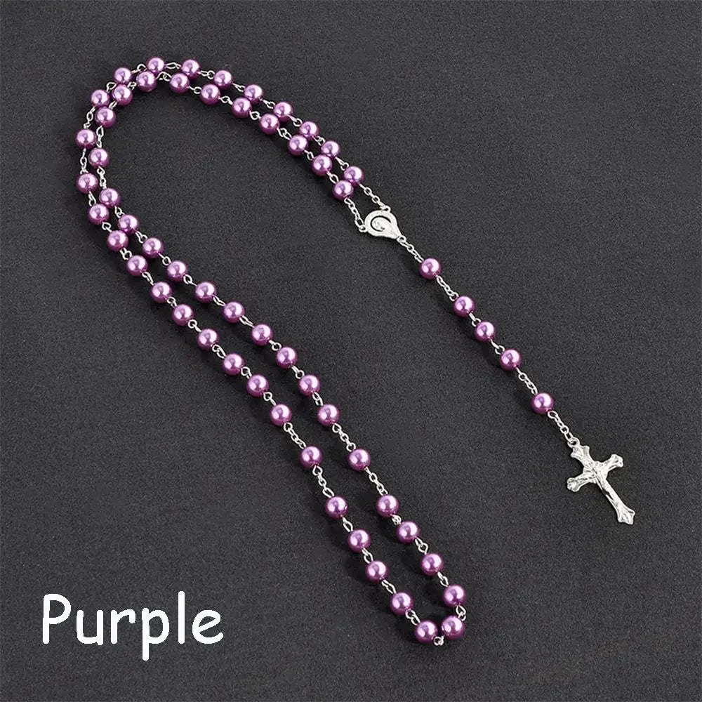 Purple rosary necklace featuring a vintage cross and Virgin Mary pendant.