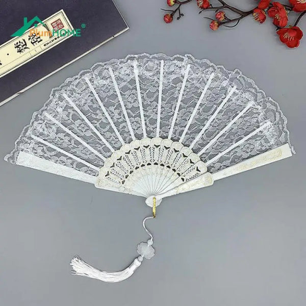 Elegant white lace folding hand fan with a delicate tassel