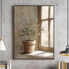 Botanical canvas wall art featuring a potted olive tree in a terracotta pot against a sunlit window.