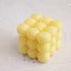A cluster of yellow soy wax candles with white wicks