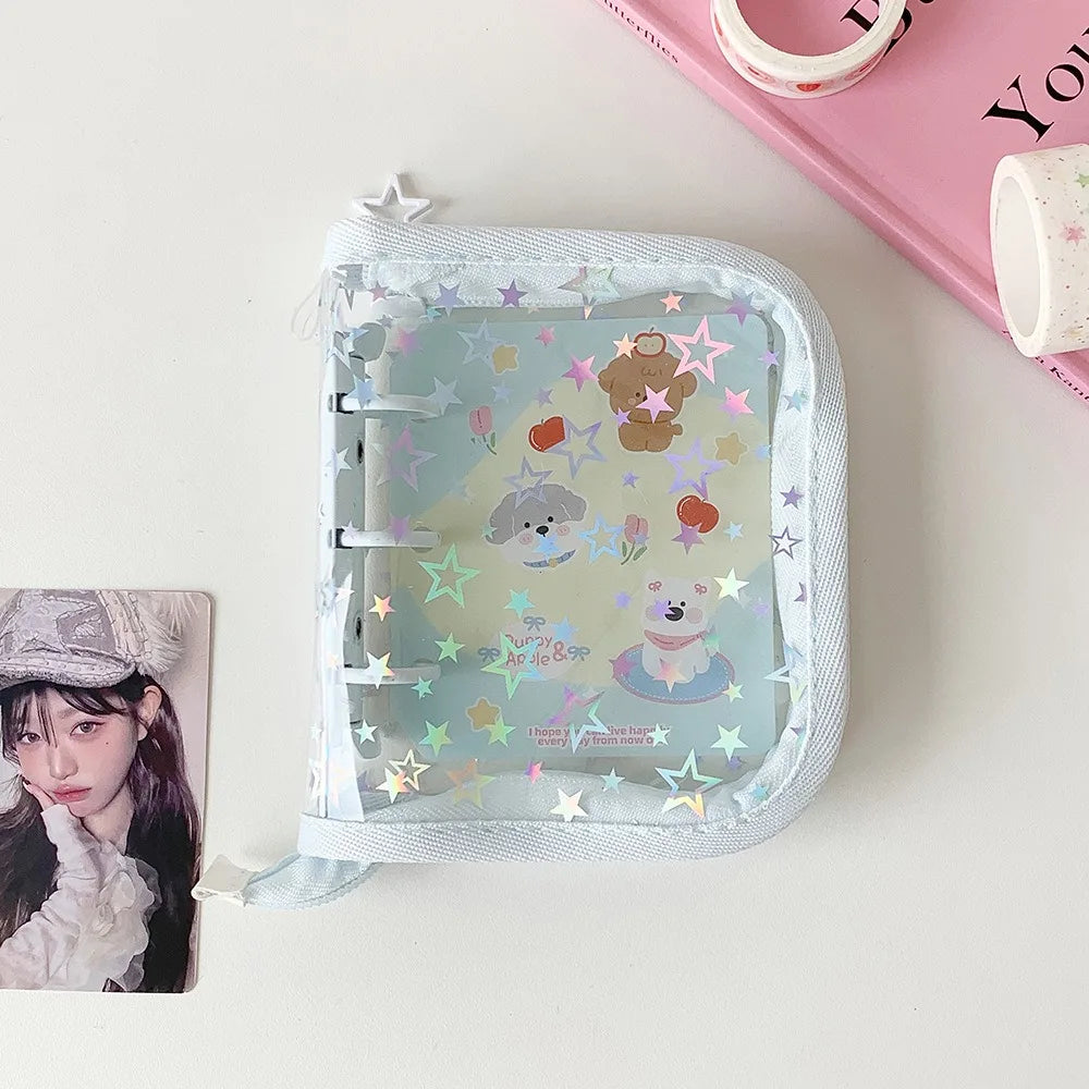 A clear plastic binder with a soft fabric cover featuring glitter stars and cute animal illustrations for collecting