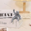 A gray collectible figurine of Rocky from Project Hail Mary standing on a white box.