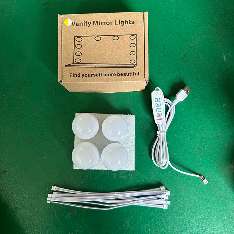 A box of vanity mirror lights with four white light bulbs and an electrical cord.