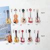 A set of five guitar-shaped fridge magnets in various colors and styles for music lovers