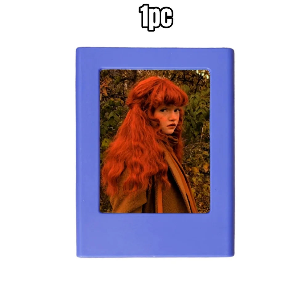 A blue retro magnetic photo frame displaying a portrait of a woman with long, fiery red hair.