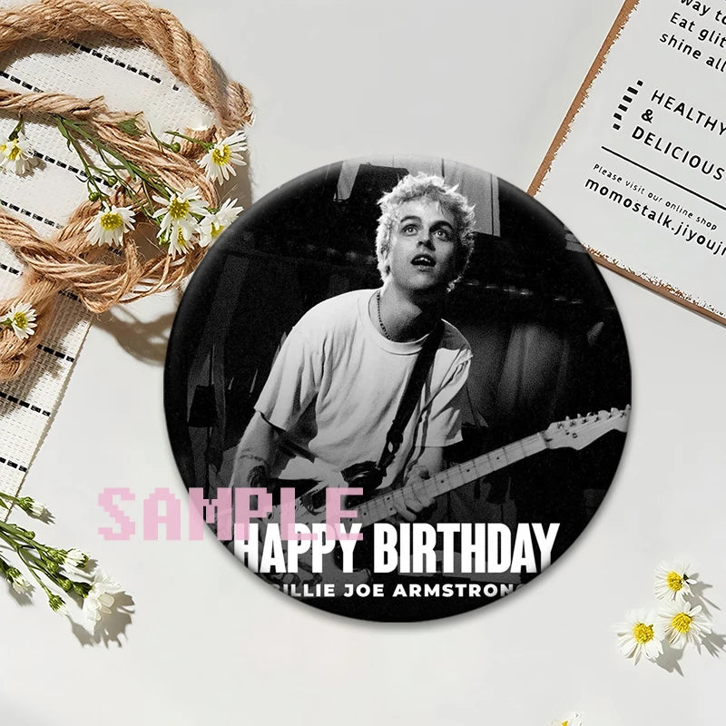 A button pin featuring a portrait of a male musician playing an electric guitar against a dark background.