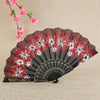 A red and white patterned bamboo flower antique folding fan displayed against a neutral background.