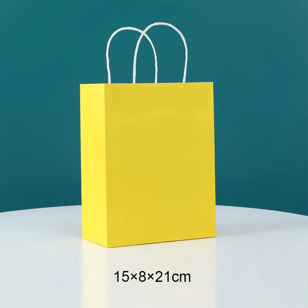 A bright yellow paper gift bag with white handles against a teal background.