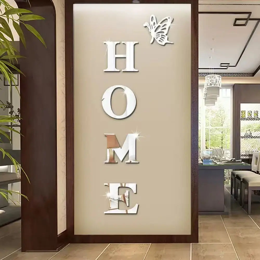 A decorative wall sticker set featuring the word HOME in silver acrylic letters and a butterfly silhouette on a beige backgro