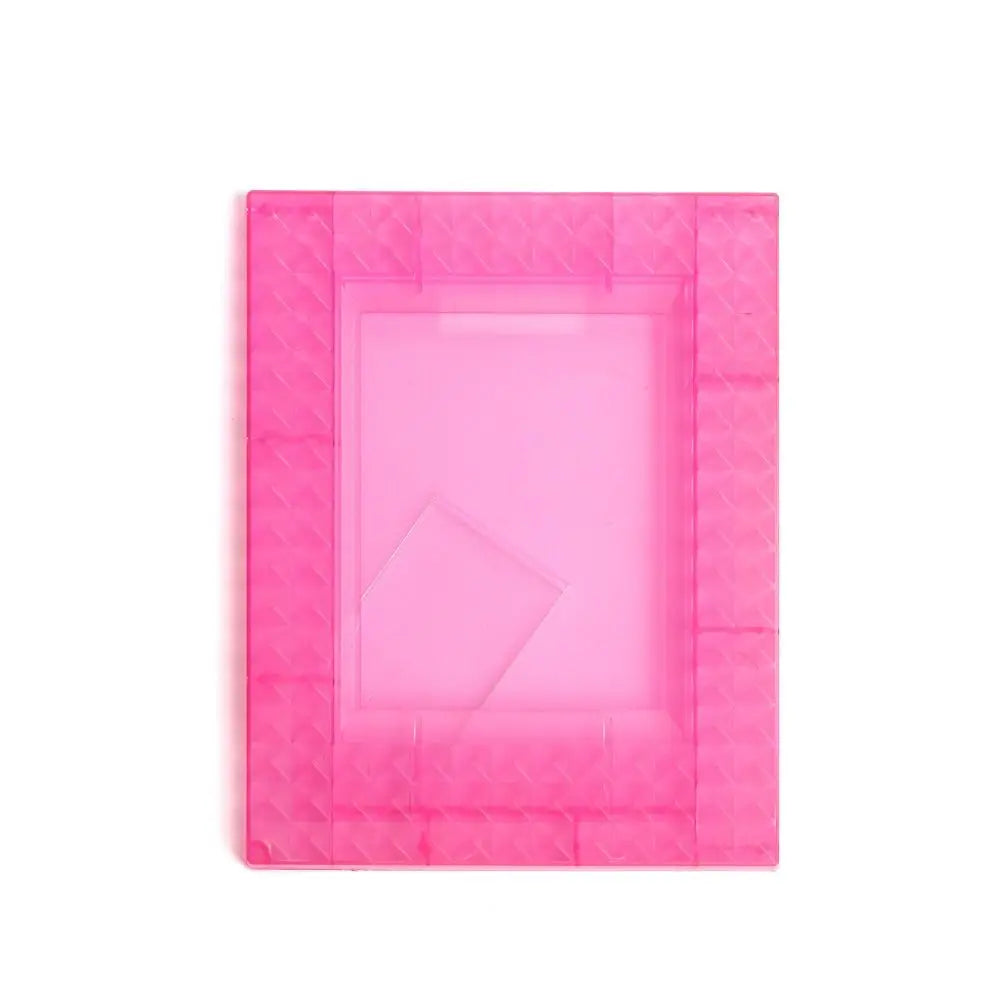 A pink mini film frame designed to hold Fuji Instax instant photos.