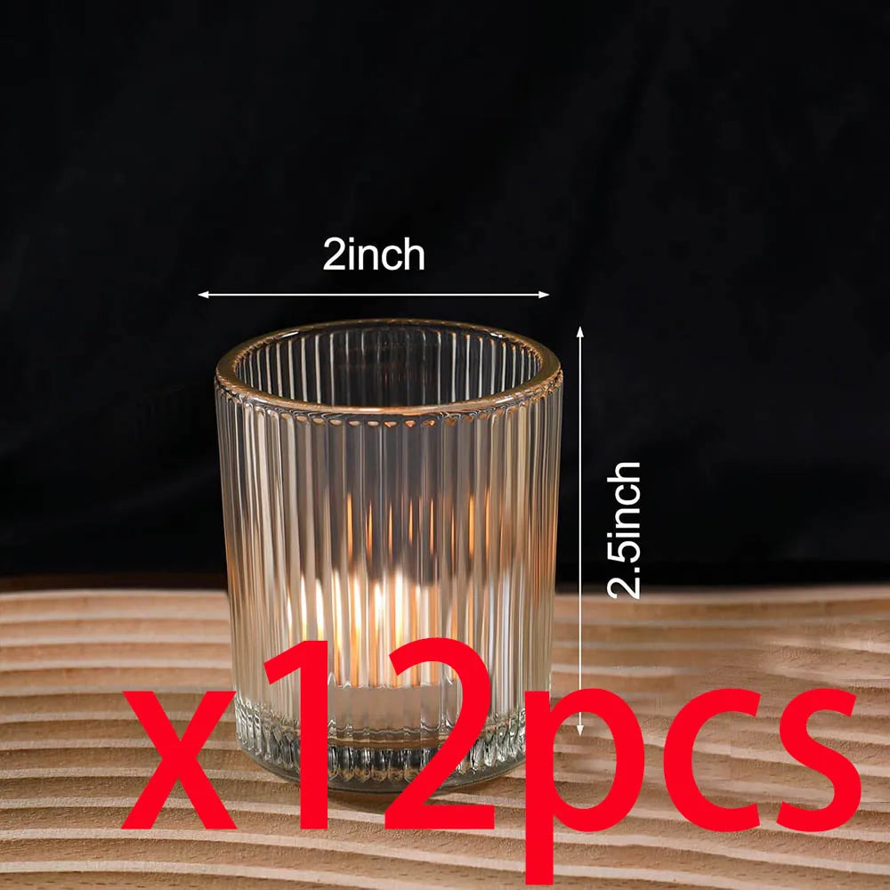 A clear glass votive candle holder with vertical stripes, shown on a wooden surface.