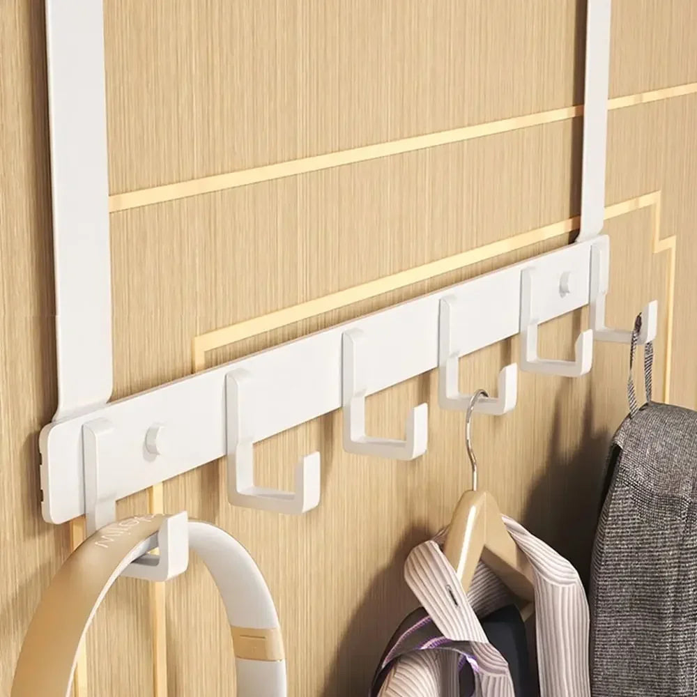 White heavy duty aluminum door hooks mounted on a wooden panel, used for hanging clothes.