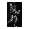 A muscular male bodybuilder posing with a flexed arm, captured in a black and white photograph.