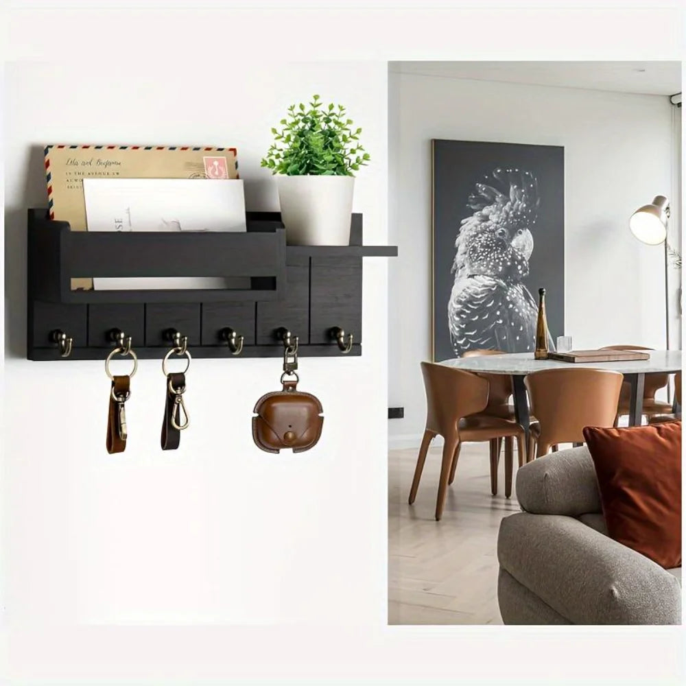 A black wooden key holder with six hooks and a mail sorter displayed on a white wall.