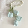 Handmade pearl chain orchid key ring featuring light green and pale blue crocheted flowers