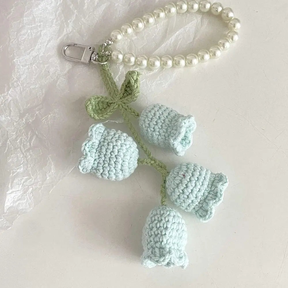 Handmade pearl chain orchid key ring featuring light green and pale blue crocheted flowers