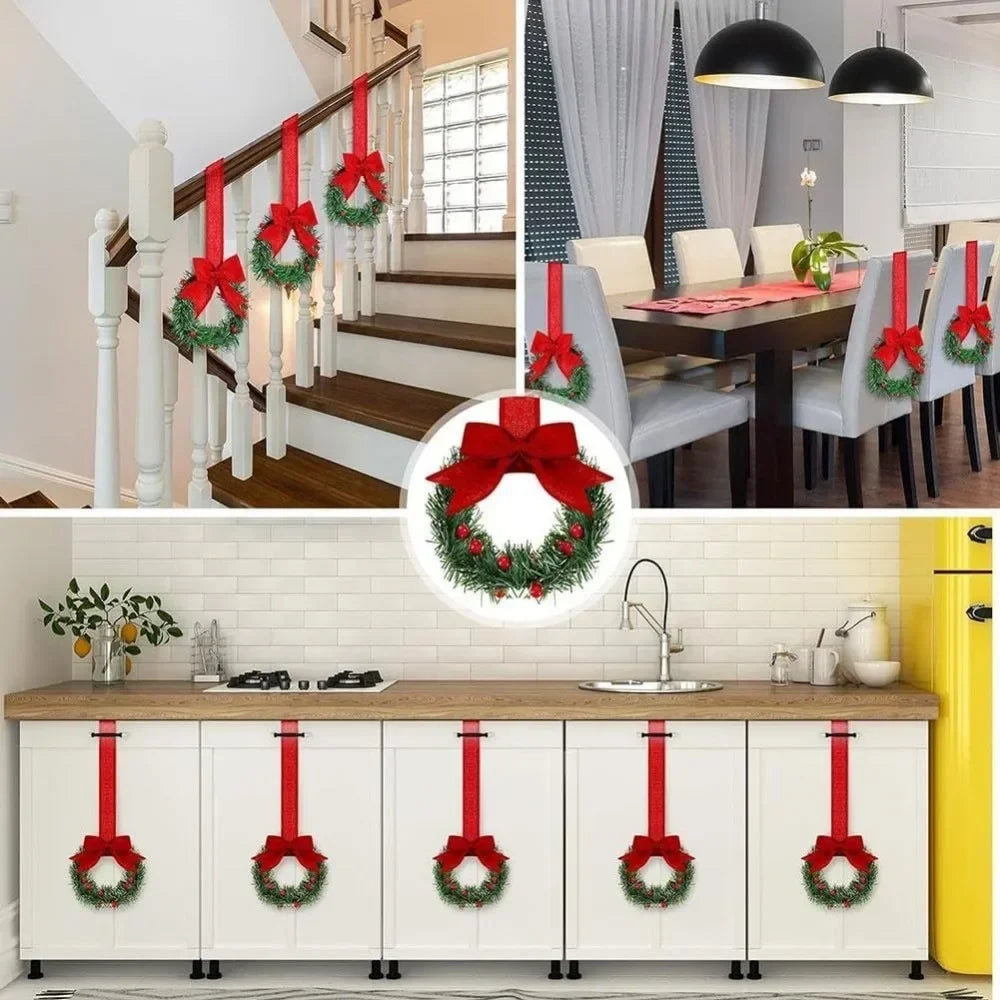 Set of four mini Christmas wreaths with red ribbon bows and green berries displayed on a white cabinet.