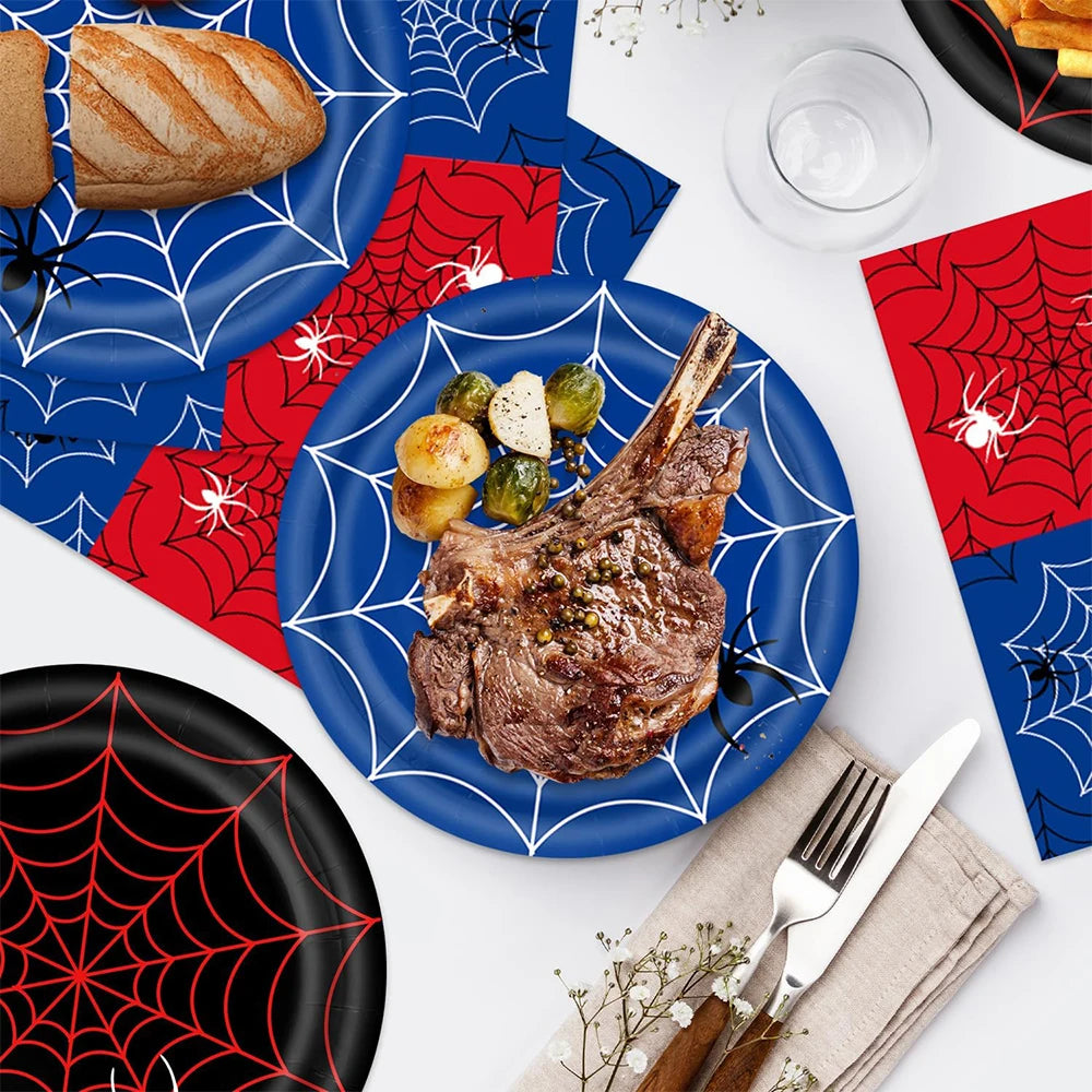 A set of red and blue spider web themed party supplies including a plate, bread, and decorative banners.