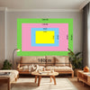 A living room scene featuring a large framed artwork with colored blocks and a sofa.