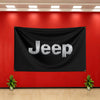 A black banner with the word Jeep in silver lettering hangs on a red wall.