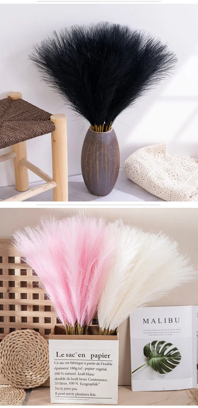 A bundle of pink and white artificial pampas grass stems in a ceramic vase for home decor