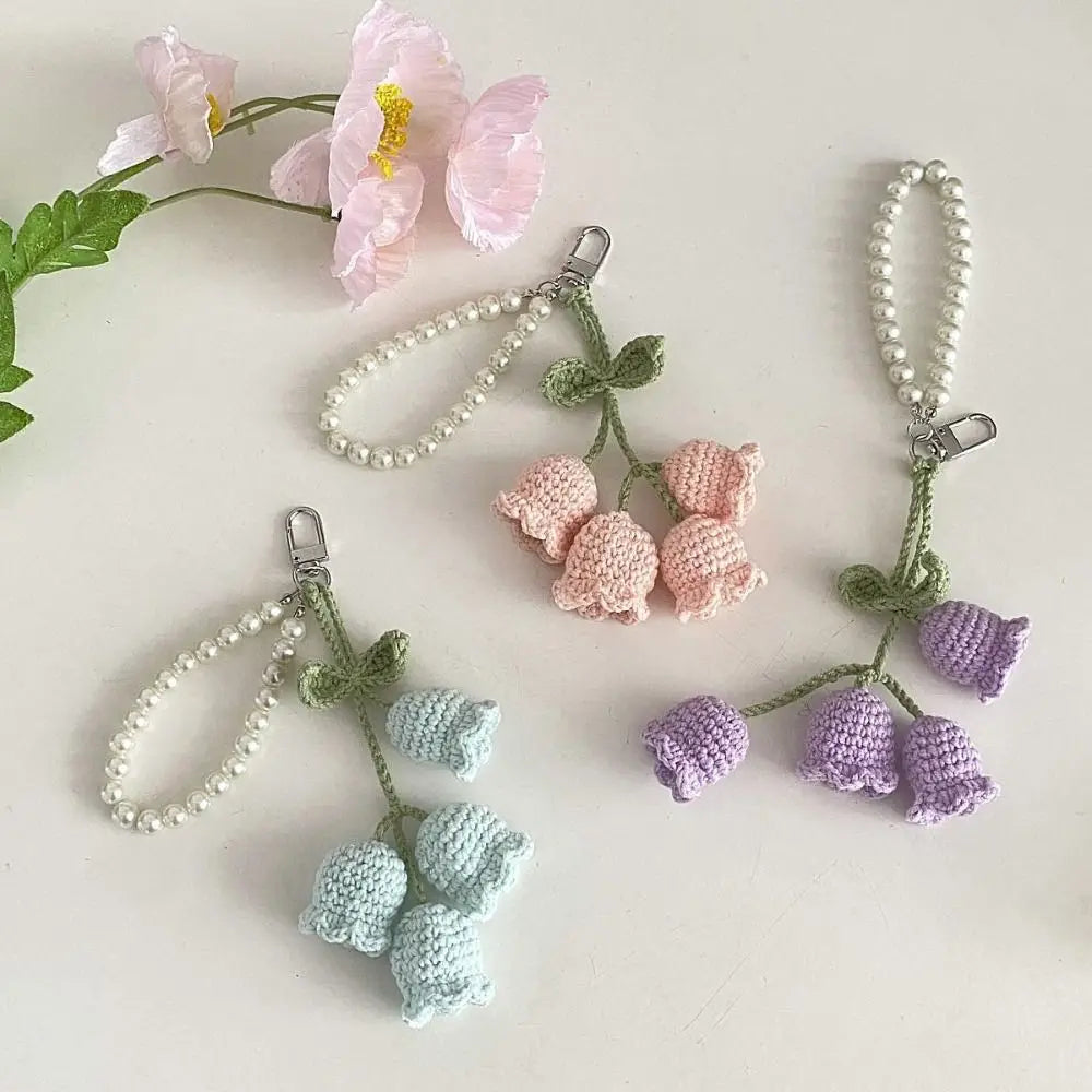 Handmade pearl chain orchid key rings featuring pink and purple floral elements.