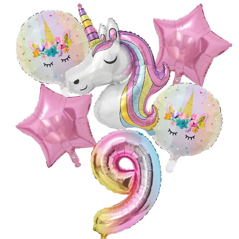 A collection of pink and iridescent foil balloons, including a unicorn balloon, star balloons, and a large number balloon.