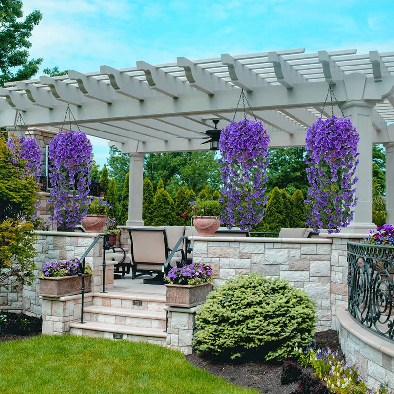Artificial violet ivy hanging garland displayed on a stone pergola and garden setting.