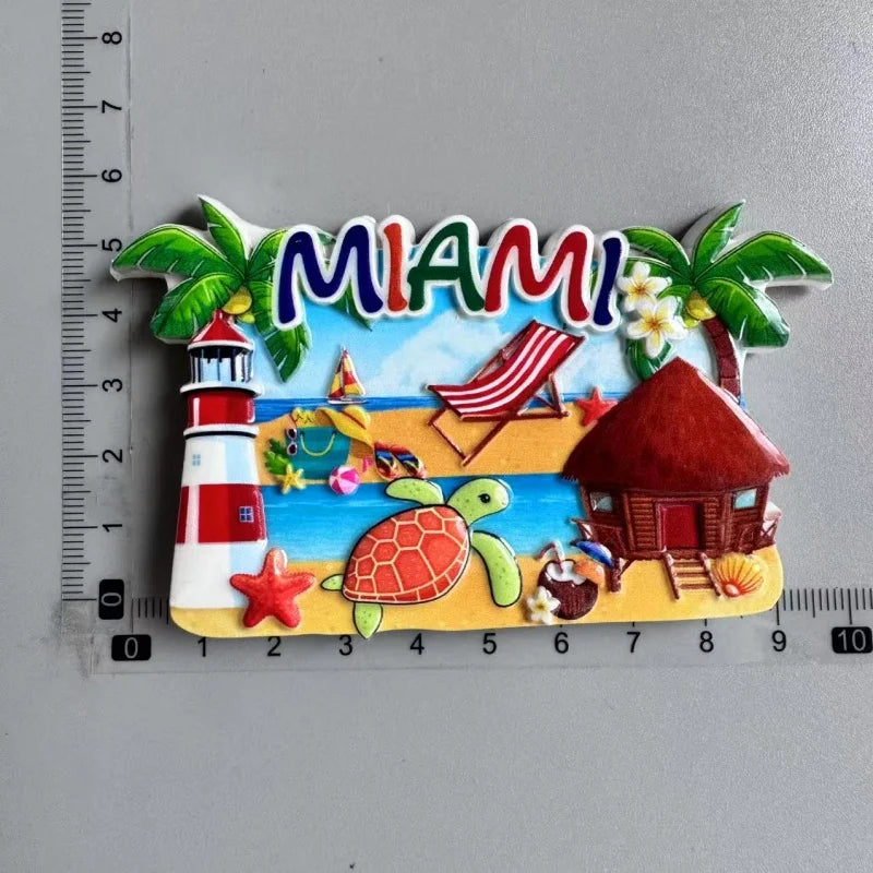 A set of colorful fridge magnets featuring a tropical theme including palm leaves, a city name sign, a lighthouse, a beach sc