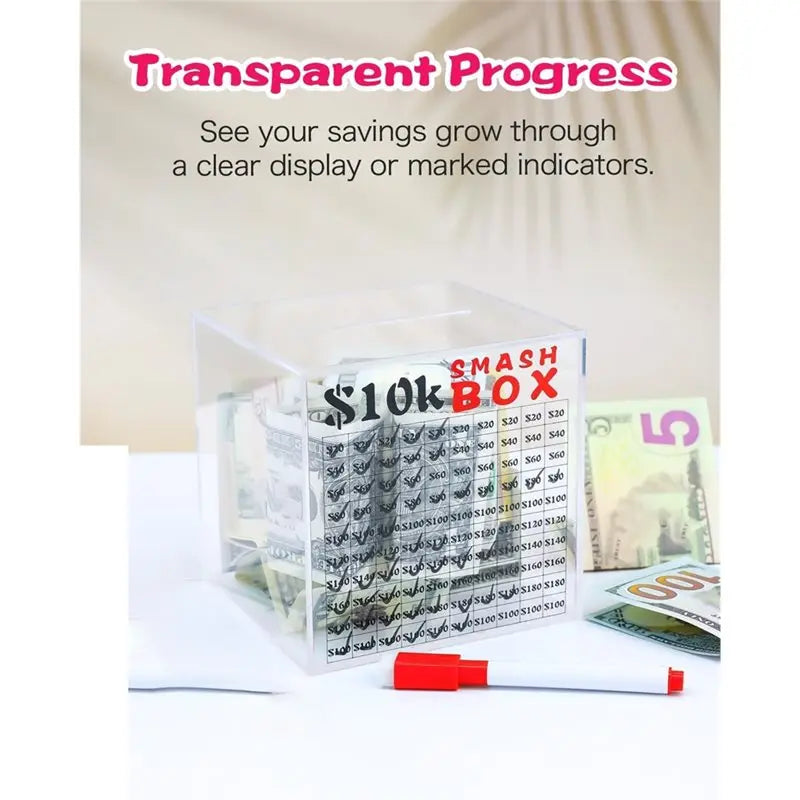 Clear acrylic smash piggy bank for a savings challenge with cash and paper bills.