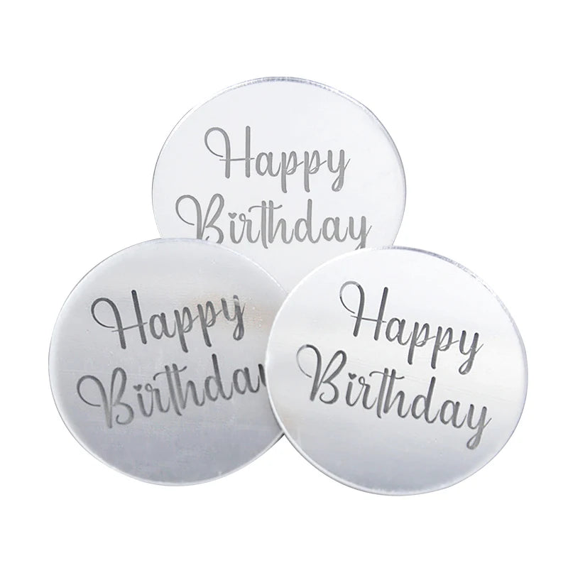 A set of ten silver acrylic birthday toppers with the text Happy Birthday engraved on them.