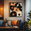 A framed canvas art print featuring a collection of black and orange vinyl records on a neutral wall.