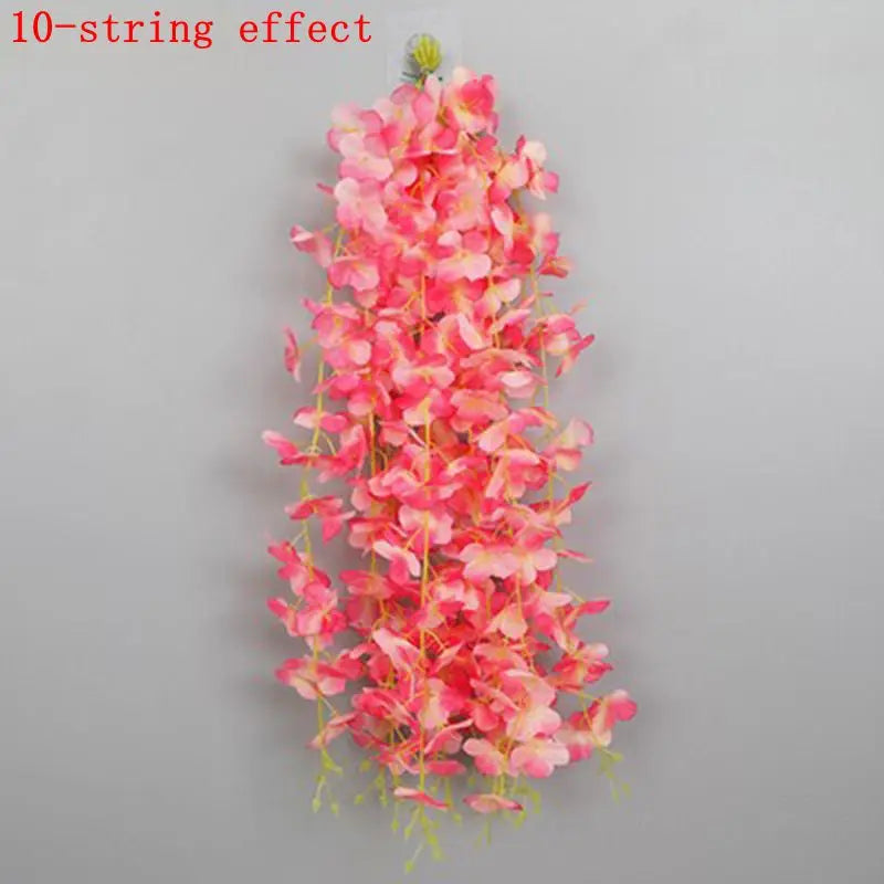 A vertical arrangement of pink and red artificial wisteria flowers forming a long, cascading effect.