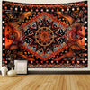 Bohemian sun and moon tapestry wall hanging featuring intricate geometric patterns in orange, black, and gold tones.