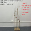 A set of gold metal candelabra stands displaying various heights and a wide base.