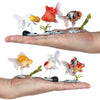 A hand holds several realistic goldfish aquarium decor figurines, including red, orange, and white fish.