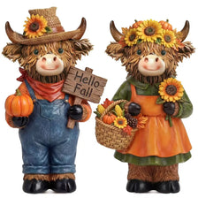 A set of two rustic wooden Highland cow figurines decorated with pumpkins and autumn foliage.