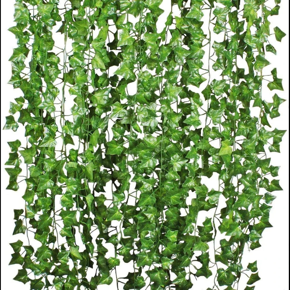 A dense green artificial ivy garland set with variegated leaves hanging vertically.