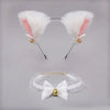 A set of kawaii cat ear headband and a white bow choker with gold accents.