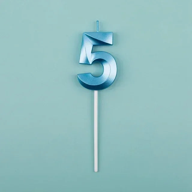 A blue number five candle against a light teal background.