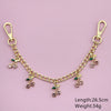 Gold chain necklace featuring small green and pink glass stone cherry charms