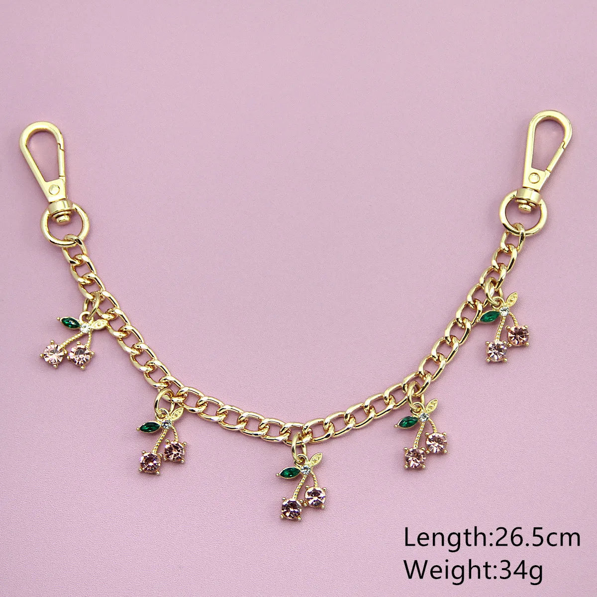 Gold chain necklace featuring small green and pink glass stone cherry charms