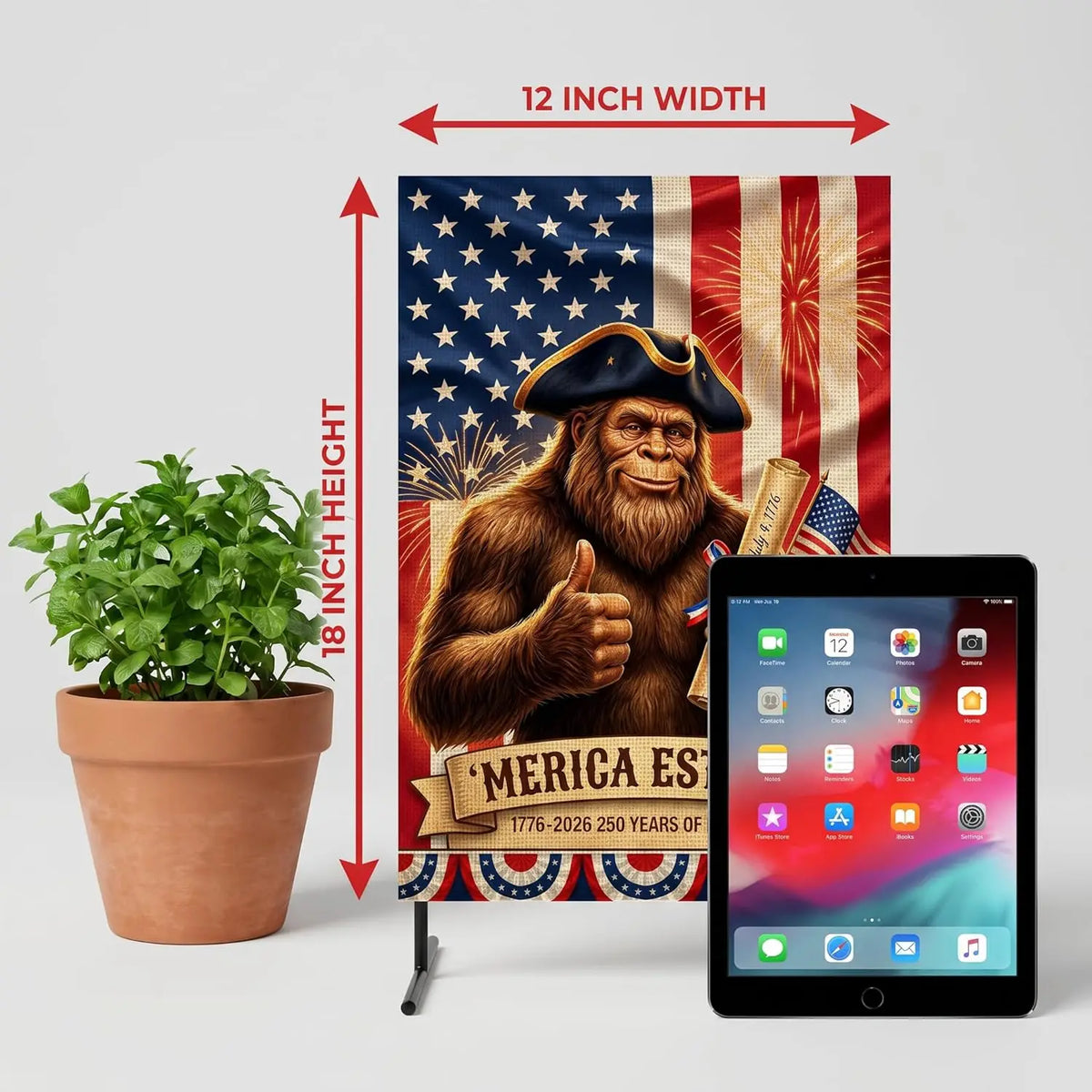 A patriotic garden and house flag featuring a bear with a thumbs up and the text MERICA EST 1776-2026