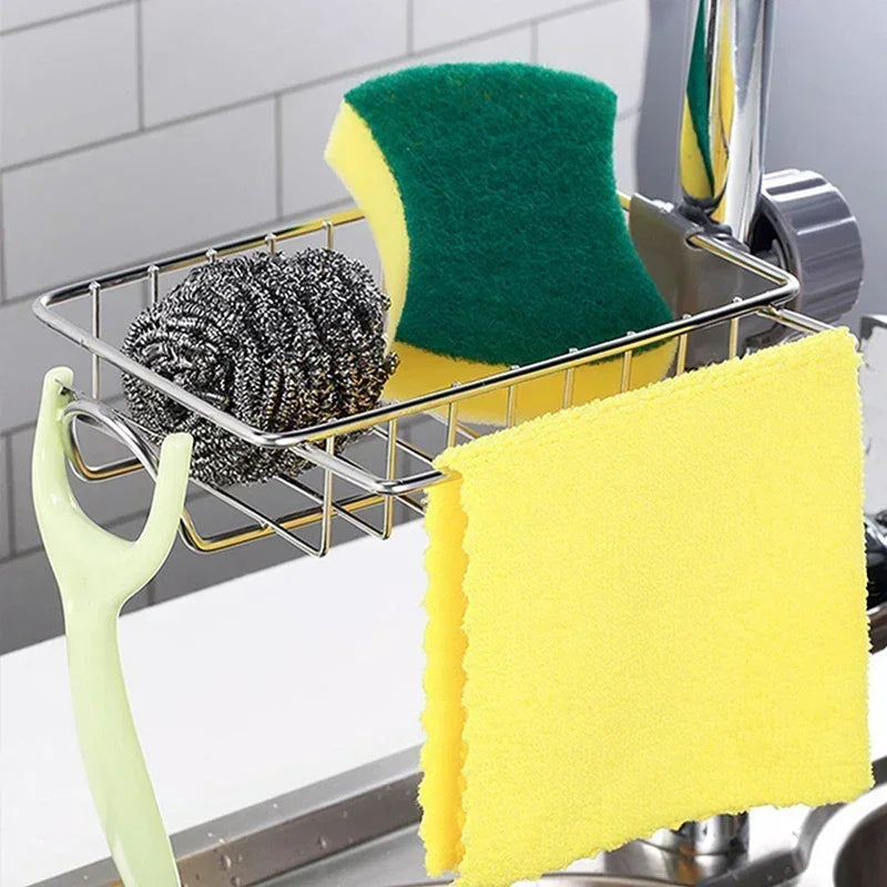A faucet-mounted kitchen organizer holding a green sponge and a yellow sponge in a metal rack.