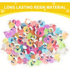 A pile of colorful glow-in-the-dark resin cruise duck decorations in various shades of pink, purple, yellow, and green.