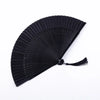 A black traditional Chinese folding fan with fine pleats, shown open and angled.