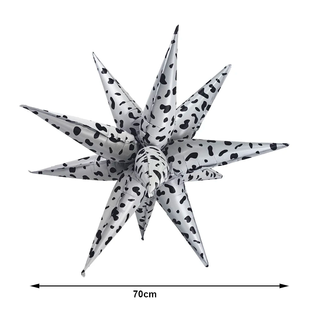 Silver foil balloon shaped like a star with a black cow print pattern for a farm-themed party