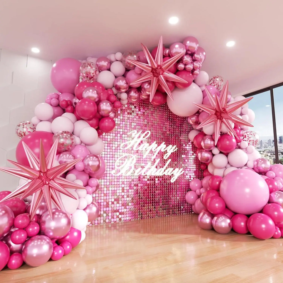 A pink and silver balloon garland decoration featuring metallic confetti balloons and star accents for a birthday backdrop.